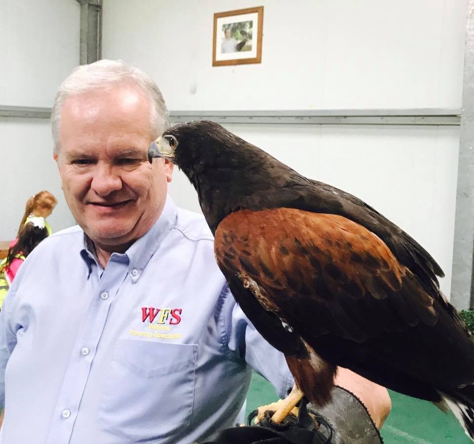 John Wilson, director of Wilson's Flooring Specialists, with a bird of 
prey